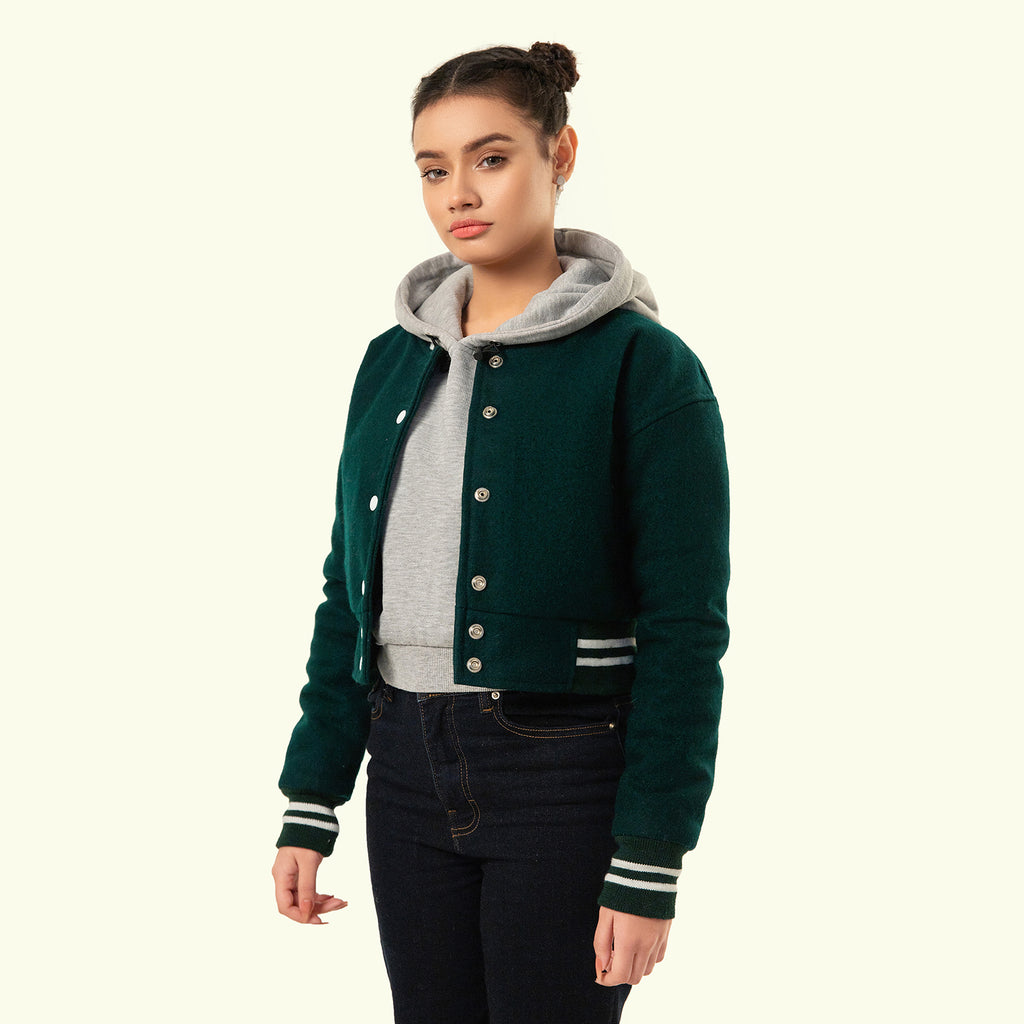 Person wearing a Green crop varsity jacket on a white background