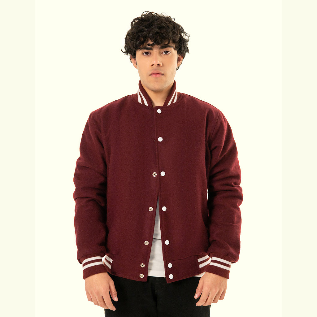 Person wearing a maroon varsity jacket with white buttons and trim on a white background