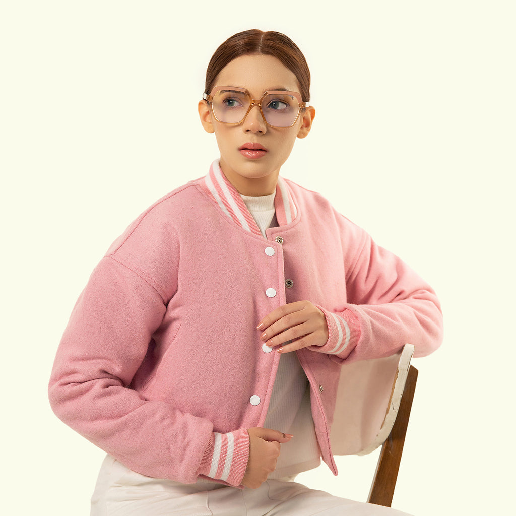 Person wearing a Pink crop varsity jacket  on a white background