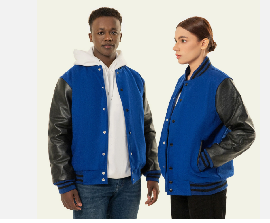 Two people wearing blue letterman jackets with black sleeves on a white background